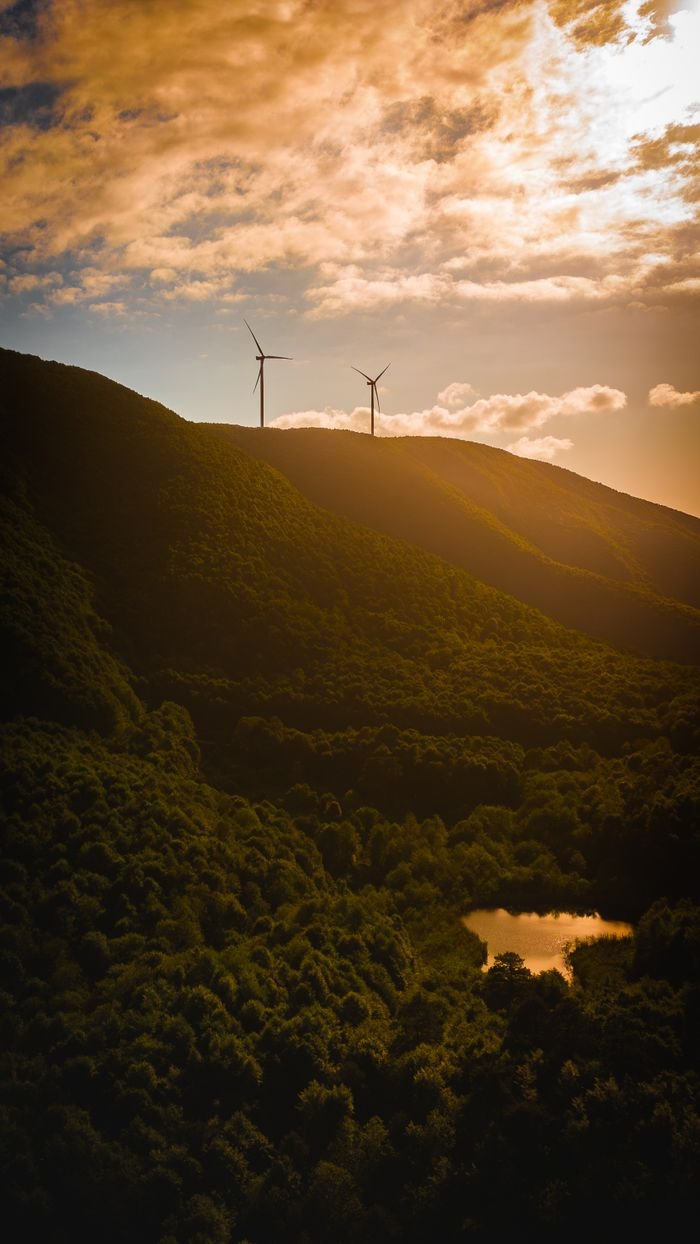 A stunning view of Yalova's lush hills and wind turbines at sunset, creating a serene and sustainable scene.